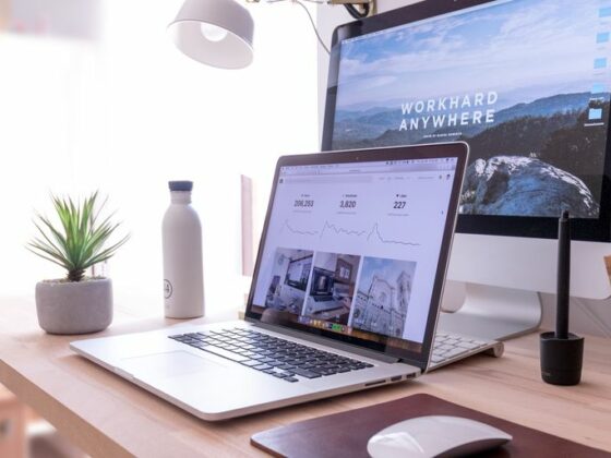 MacBook Pro on table beside white iMac and Magic Mouse