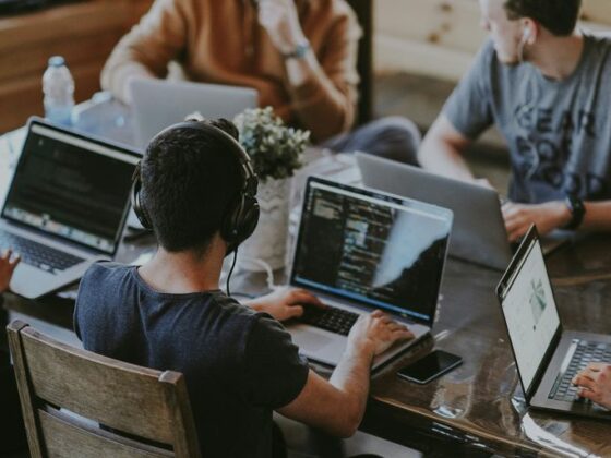 group of people using laptop computer